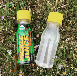 Pickle Juice Shot and Clear Shot Bottle on Grass